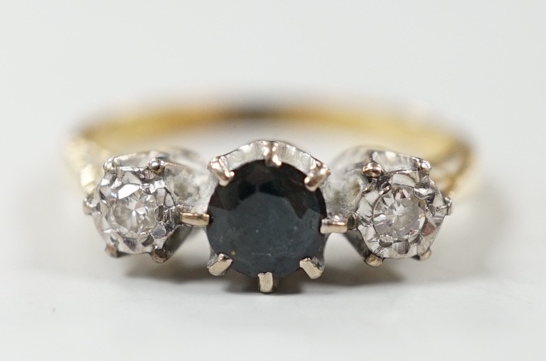 A modern 18ct gold, single stone sapphire and two stone illusion set diamond ring, size N, gross weight 3.4 grams.